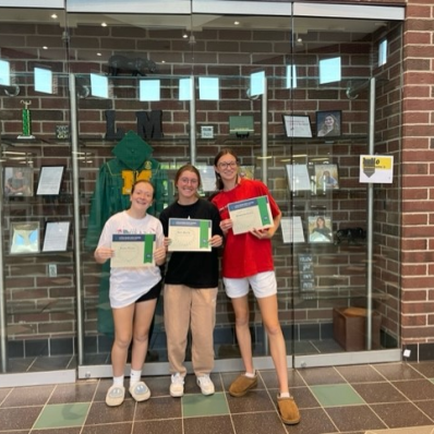 students smiling holding certificate